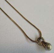 A small diamond and pearl pendant on fine link chain.