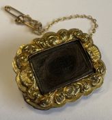 A rectangular gold-mounted mourning brooch.