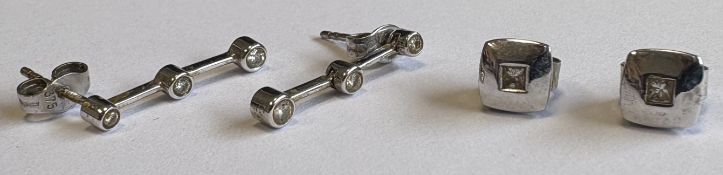 Two pairs of diamond-set drop earrings.