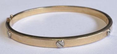 A 9 carat two-colour bangle.
