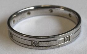 A small diamond wedding band set in platinum.