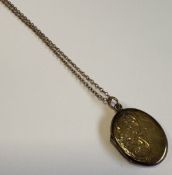 A 9 carat neck chain together with an engraved locket.