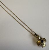 A small gold single-stone pendant on fine link chain.