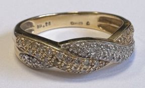 A 14 carat gold diamond twist ring.