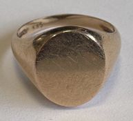 A 14 carat rose gold signet ring.