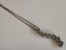 A small diamond-set pendant on fine link chain.