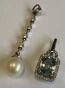 A 9 carat diamond-set pendant together with one other.