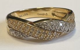 A 14 carat gold rose diamond twist ring.