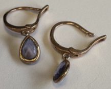 A pair of small amethyst drop earrings.