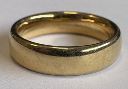 A plain 14 carat gold wedding band.