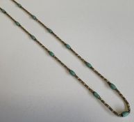 A turquoise-mounted necklace with ring clasp.