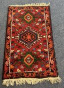 A small prayer rug decorated in red ground.