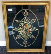 A gilt framed and glazed tapestry depicting birds and flowers.