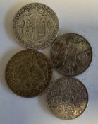 Four silver half-crown coins.