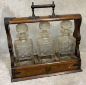 An old wooden tantalus together with key.