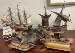 A collection of old wooden pond yachts.