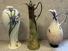 An Art Nouveau style copper-mounted ceramic ewer with floral design.