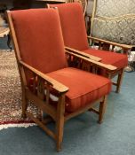A pair of oak chairs of Arts and Crafts design.
