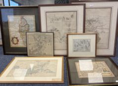 Seven framed and glazed old maps.