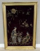 A gilt framed metallic painting on mauve velvet depicting Japanese ladies.