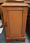 A mahogany pot cupboard with panelled door.