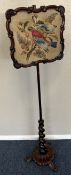 A Victorian rosewood pole screen.