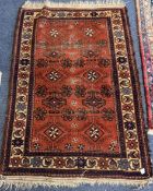 An old rug decorated in red ground. Est. £30 - £50