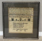 A framed and glazed sampler.