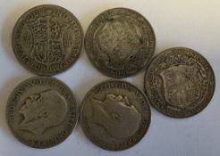 Five silver half-crown coins.