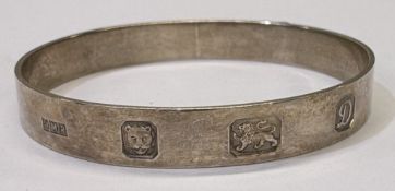 A silver bangle.
