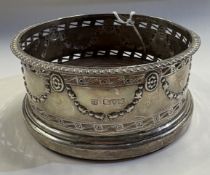 CHESTER: A silver wine coaster.