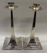 A pair of Art Deco silver riveted candlesticks.