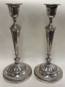 A large pair of Victorian silver candlesticks.