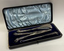 A rare cased English silver-mounted button hook, shoe horn and glove stretcher set.