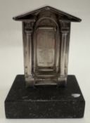 A silver model of the door to St Paul's Club.