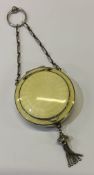 A large silver and yellow enamelled compact.