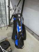 Blue and black Ping golf bag with assortment of various Ping irons