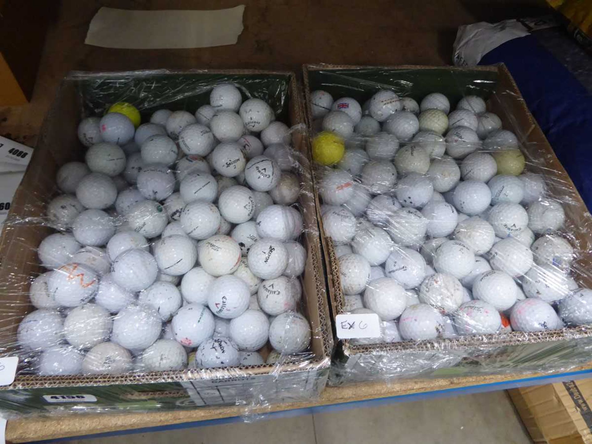 2 boxes containing a quantity of golf balls