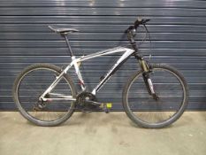 Saracen white and black mountain bike with SR Suntour XCT front fork assembly