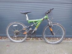 Child's green black and orange Apollo Outrage mountain bike with dual suspension