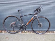 Black specialised racing bike with a carbon fibre frame