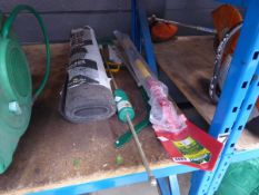 A collection of tools to include spade, saw plus a roll of felt