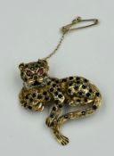 A 9ct gold leopard brooch with ruby eyes and diamond style collar, approximate weight 10.8g and