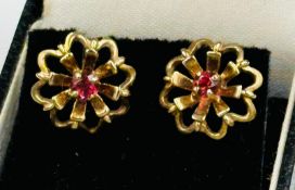 A pair of 9ct gold earrings with central stone in a floral design, approximate total weight 2.9g