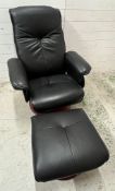 A leather swivel recliner chair with foot stool