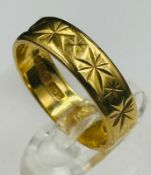 An 18ct wedding band approximate weight 3.6g and size K.5