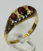 An 18ct yellow gold gold three stone ruby and diamond ring, approximate weight 2.7g and size Q