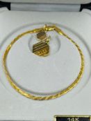 Two 14ct gold jewellery items a bracelet and charm with approximate weight of 5.6g