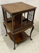 An Edwardian mahogany revolving bookcase with four fretwork supports on four cabriole legs (H78cm