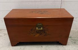 A camphor wood chest, carved to front, top and sides with brass fittings and lock (H41cm W78cm